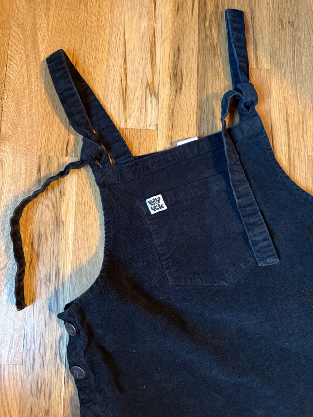 Lucy & Yak black corduroy pinafore with logo patch